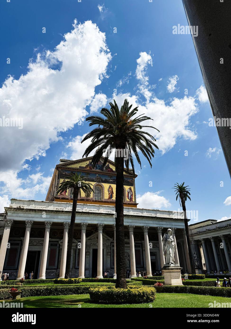 Saint Paul Column Rome Rome, Italy - July 30, 2025: Sunny temple with columns, palm trees, and ...