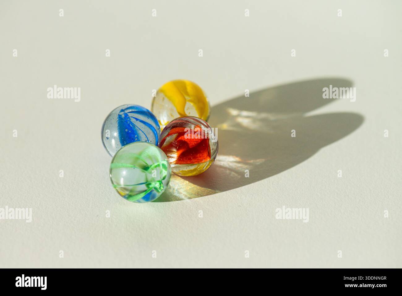 Red, green, yellow and blue cat's eyes marbles Stock Photo