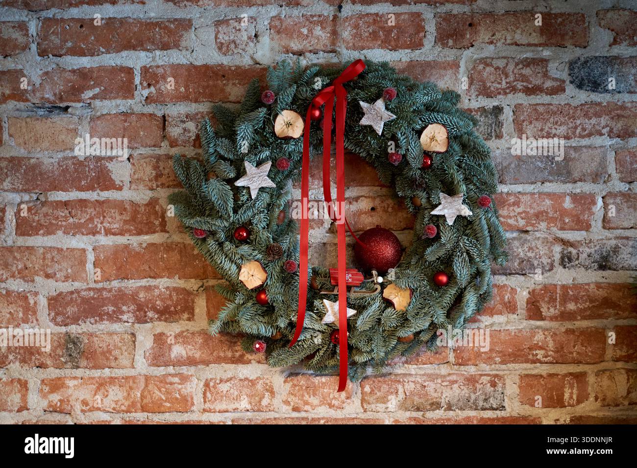 festive wreath on exposed brick, artisan storefront display evoking ...