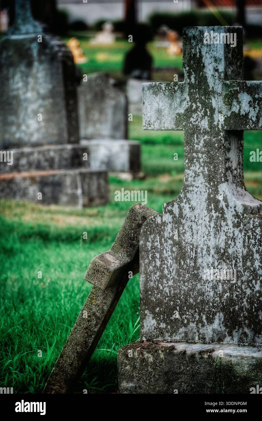 Broken gravestone in an old cemetery Stock Photo