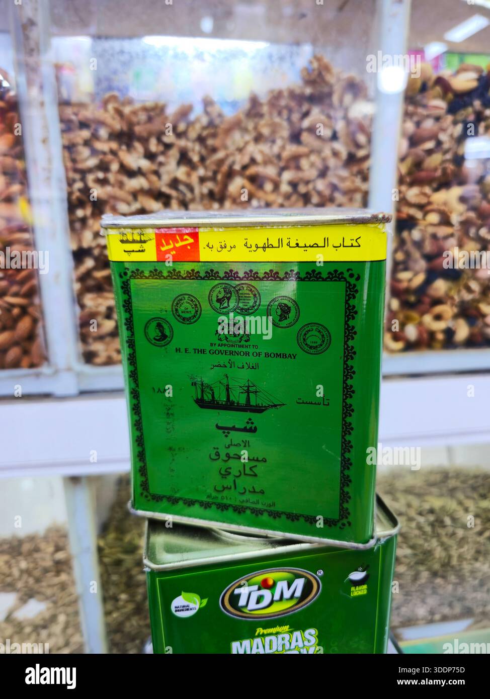 A tin can of Madras Curry Powder of the famous Ship brand displayed at a spice shop in the spice souq in Bab Al Bahrain in Manama, Bahrain. - Smartphone Captured Stock Image