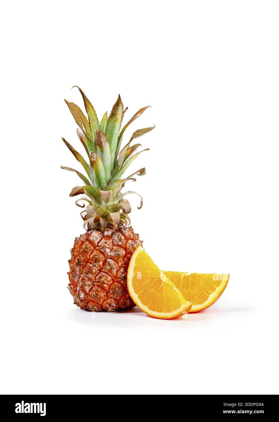 Fresh pineapple and orange slices arranged on a white background, vertical, no people Stock Photo