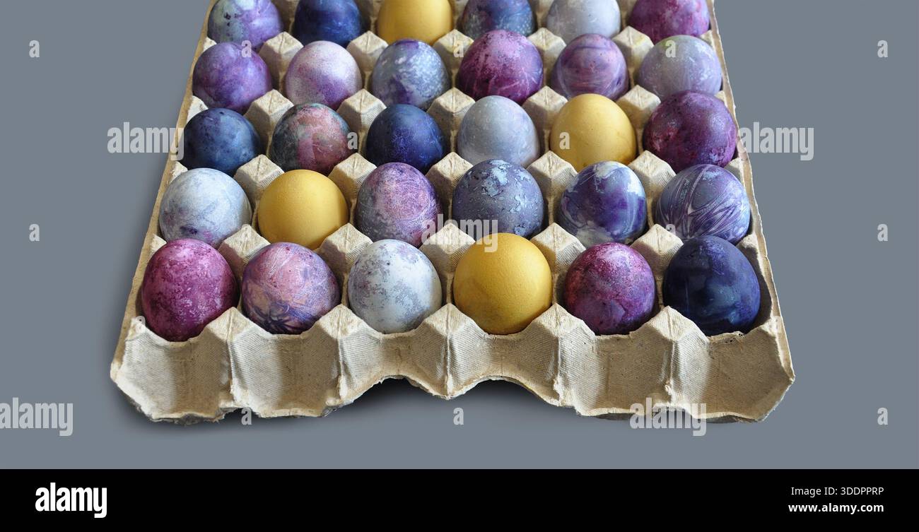 Colorful eggs patterns, 30 eggs, Easter eggs in a paper tray.. Large package of bright Easter eggs, isolated on light grey background. Spring banners Stock Photo