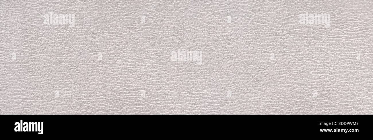 Rough gray plaster creating an uneven texture on a full frame wall surface Stock Photo