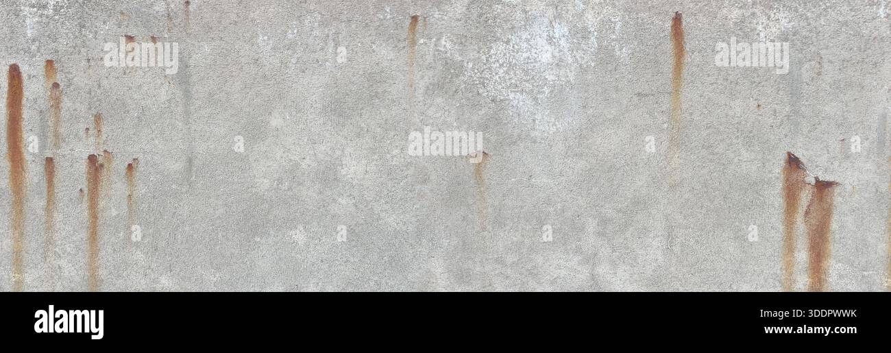 Weathered grey concrete wall showing corrosion stains and a rough texture Stock Photo