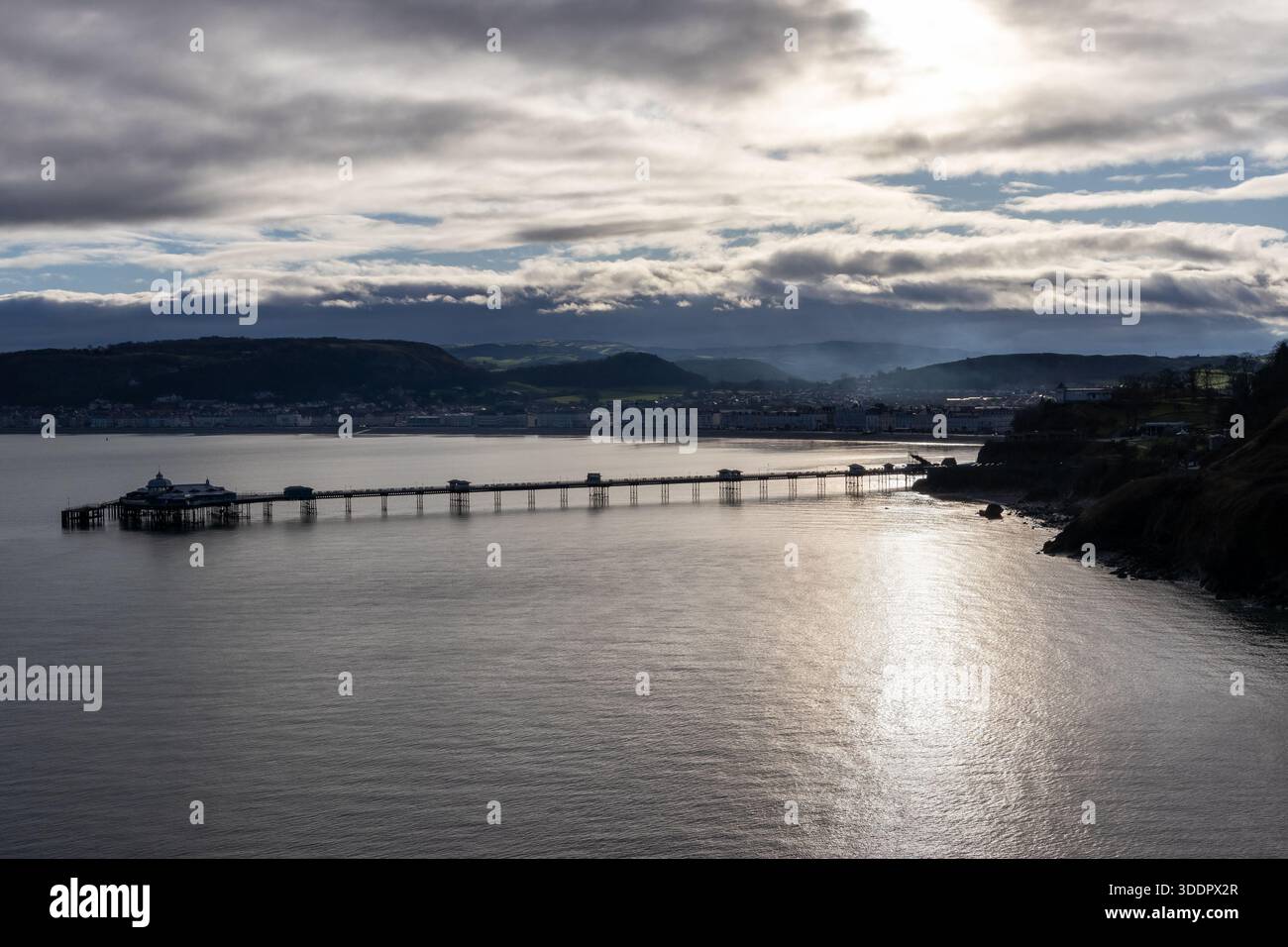 Llandudno Pier extending across the bay with calm sea and layered cloud ...