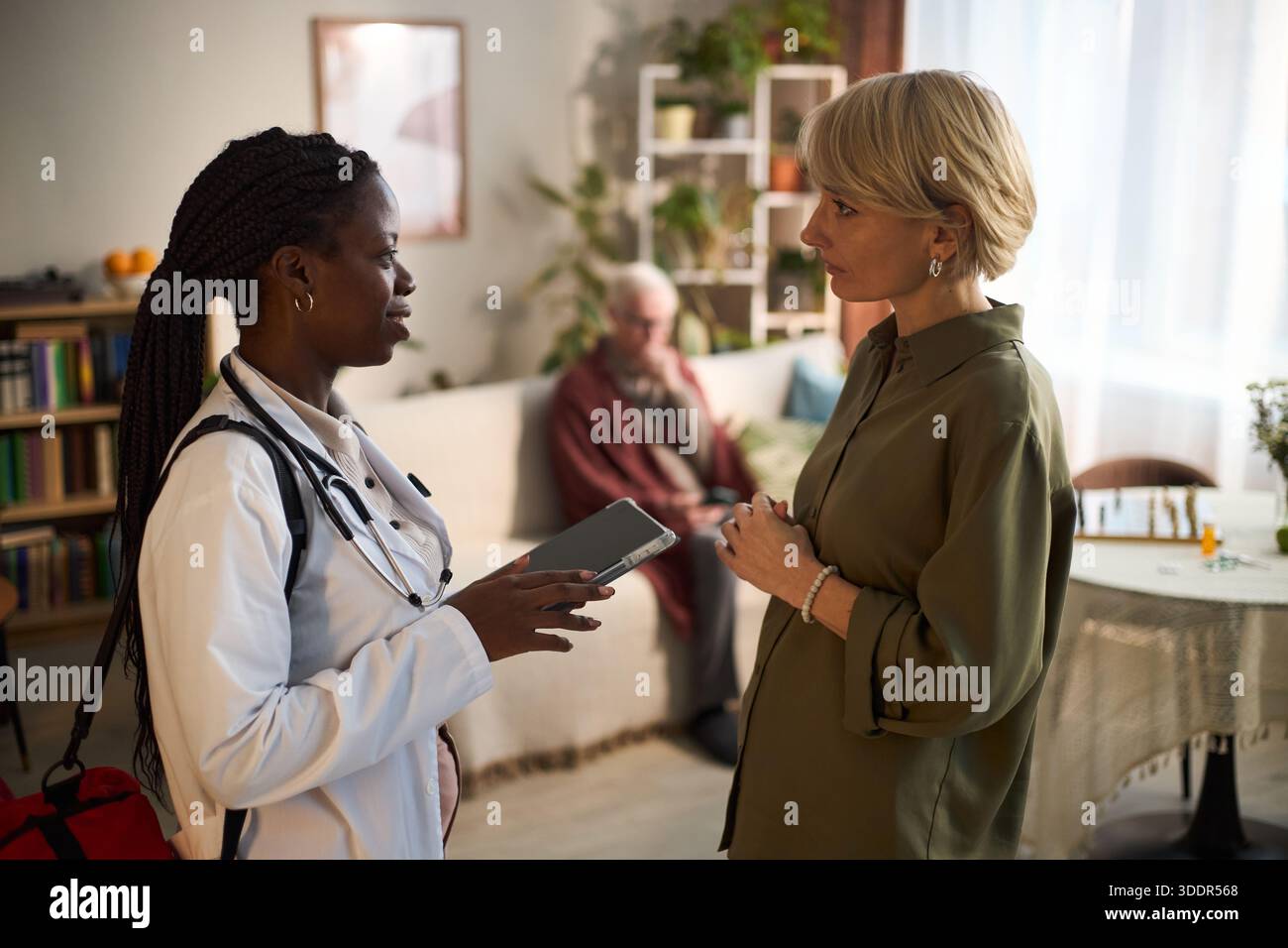 Nurse speaking young family hi-res stock photography and images - Alamy
