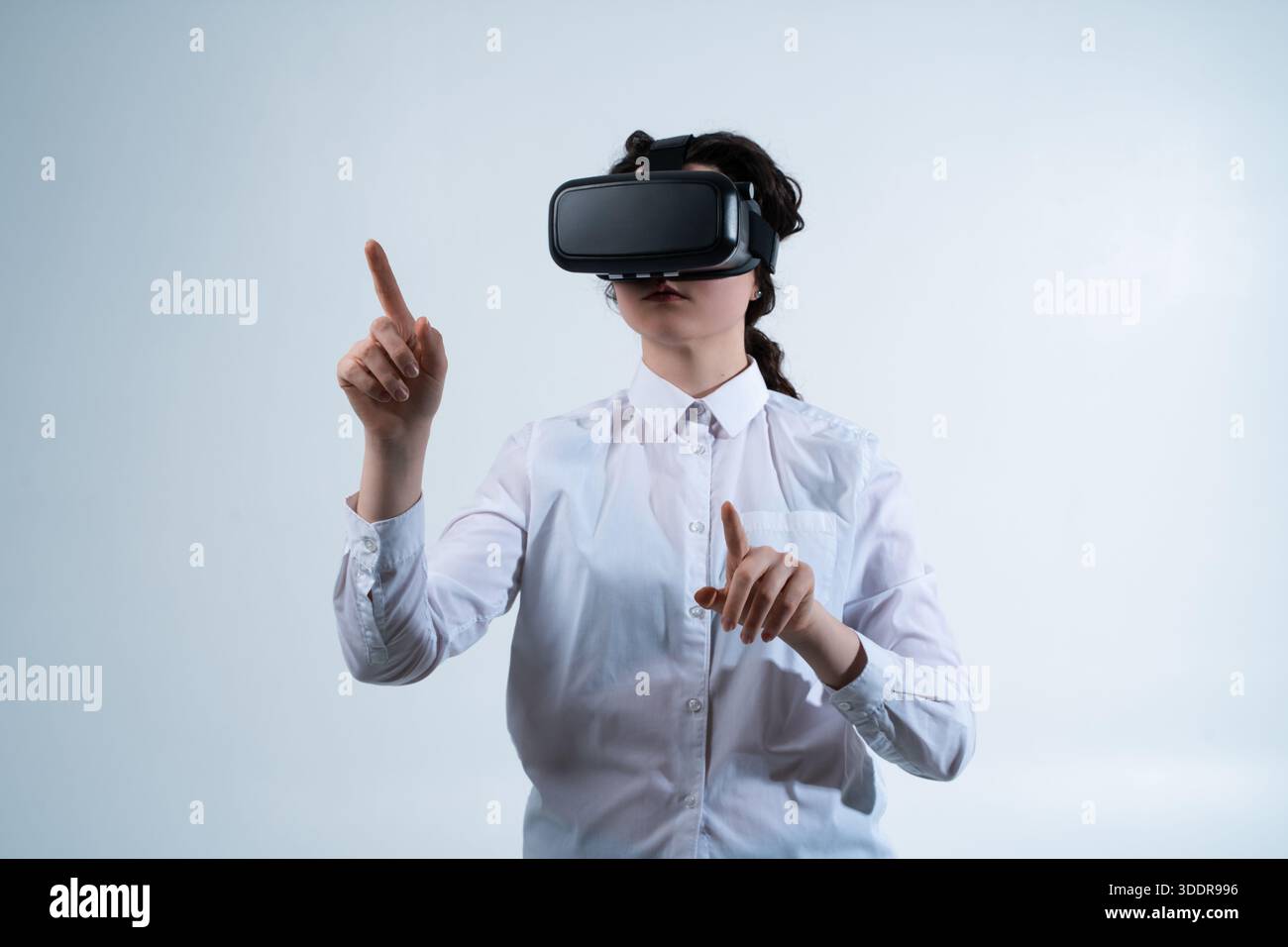 VR designer testing navigation and interface flow using hand gestures inside virtual reality design environment Stock Photo