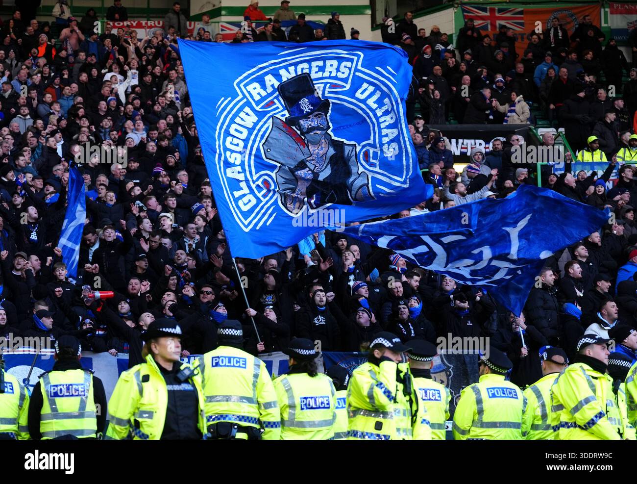 Police officers stand in a line in front of Rangers fans during the ...