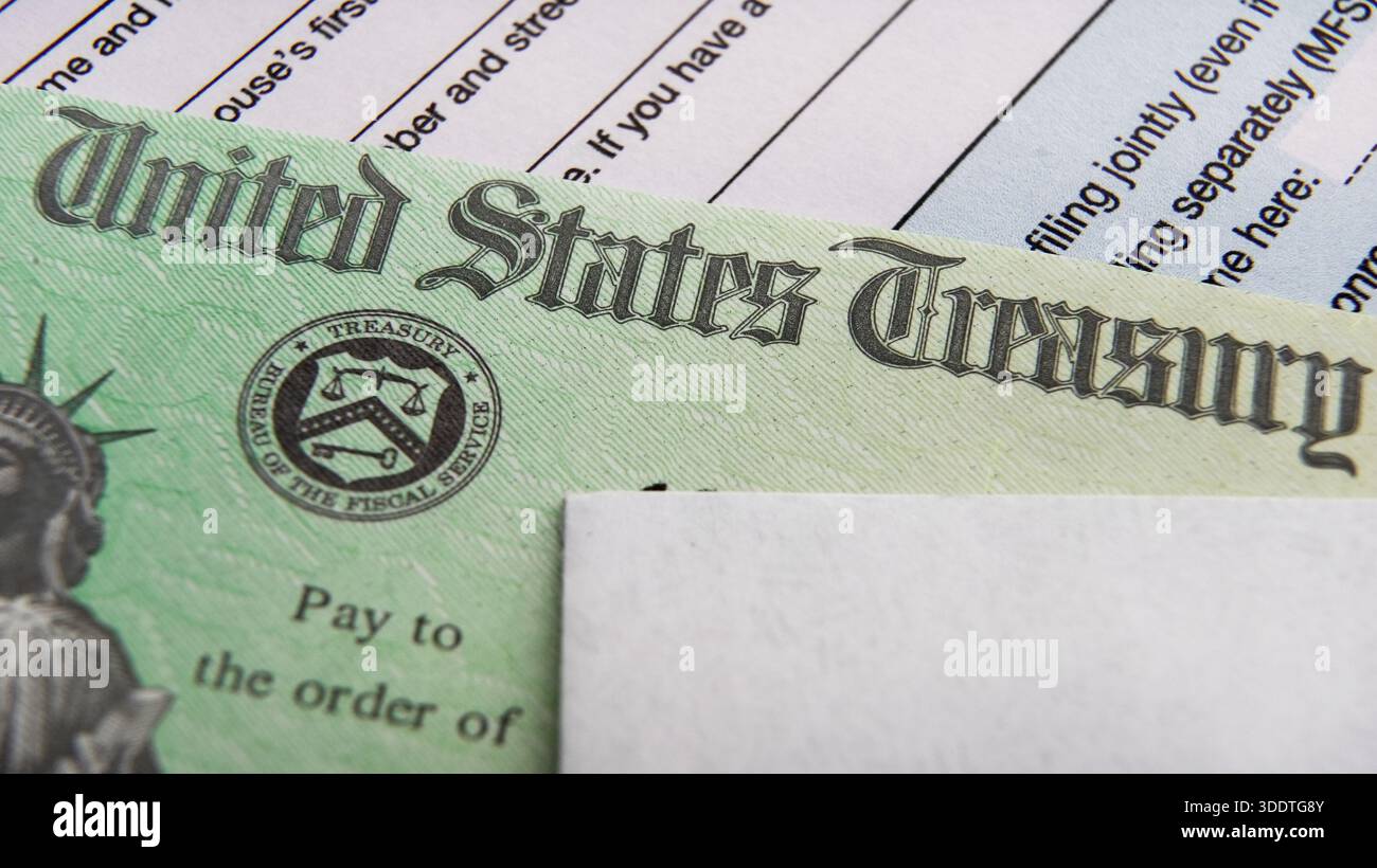 Tax Refund Cheque with tax form Stock Photo - Alamy