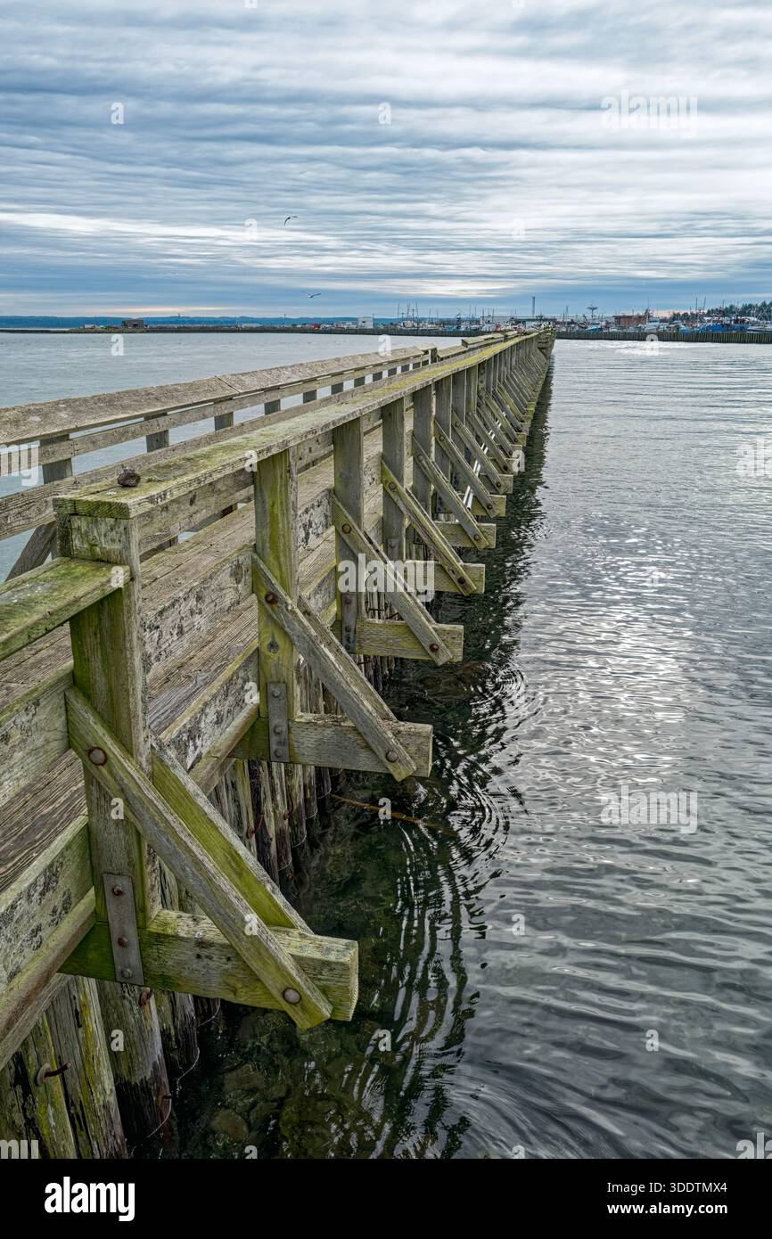 A section of the Fishermen's Boardwalk extending into the harbor at Westport in Washington, USA Stock Photo