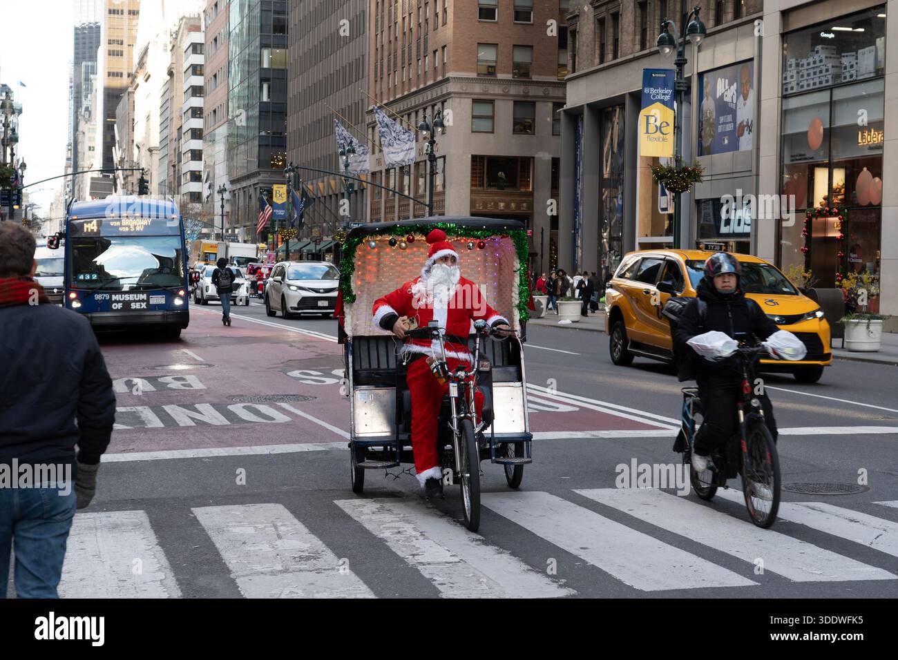 Pedicab driver dressed as Santa Claus during the Christmas holiday season  peddling down 5th Avenue in midtown Manhattan, Newn York City Stock Photo -  Alamy