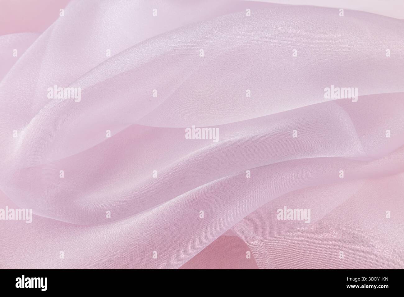 Chic large air waves of white organza on a pink background. stylish wedding background. light airy silk. shine of the fabric. Stock Photo