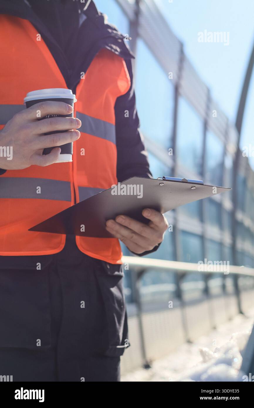 Construction worker wearing orange vest hi-res stock photography and ...