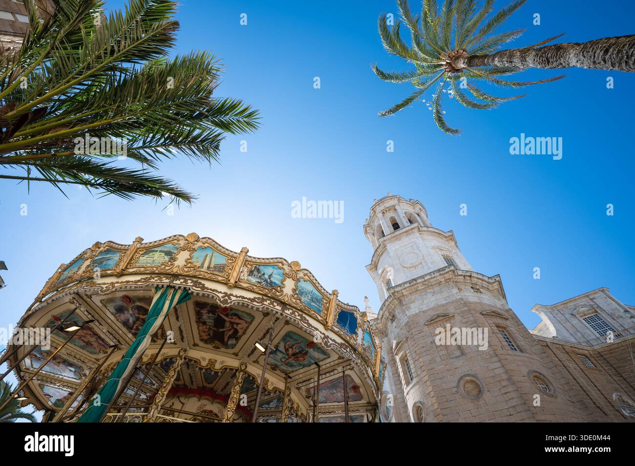 Tower of Cadiz Cathedral near Nostalgic Carousel. Low Angle view Stock Photo