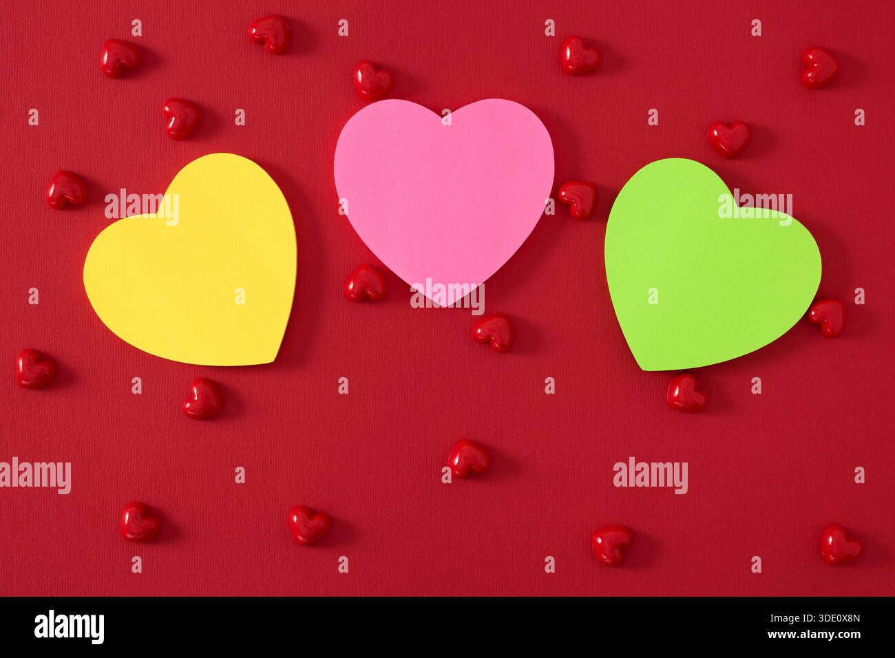 Heart shape sticky notes laying on rose petals Stock Photo