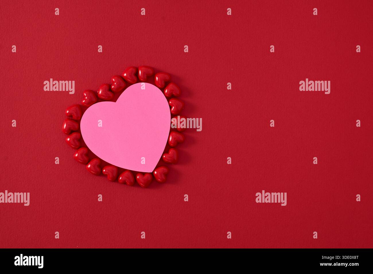 Heart shape sticky notes laying on rose petals Stock Photo