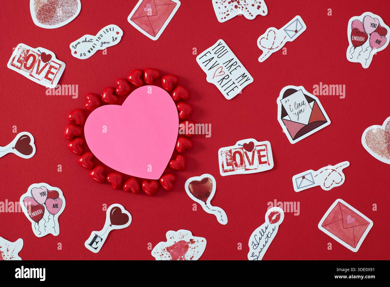 Heart shape sticky notes laying on rose petals Stock Photo