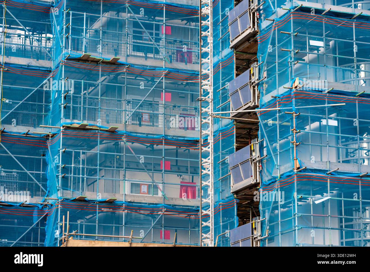 Scaffold Security Cladding Large scaffolding with safety netting erected on a block of flats or ...