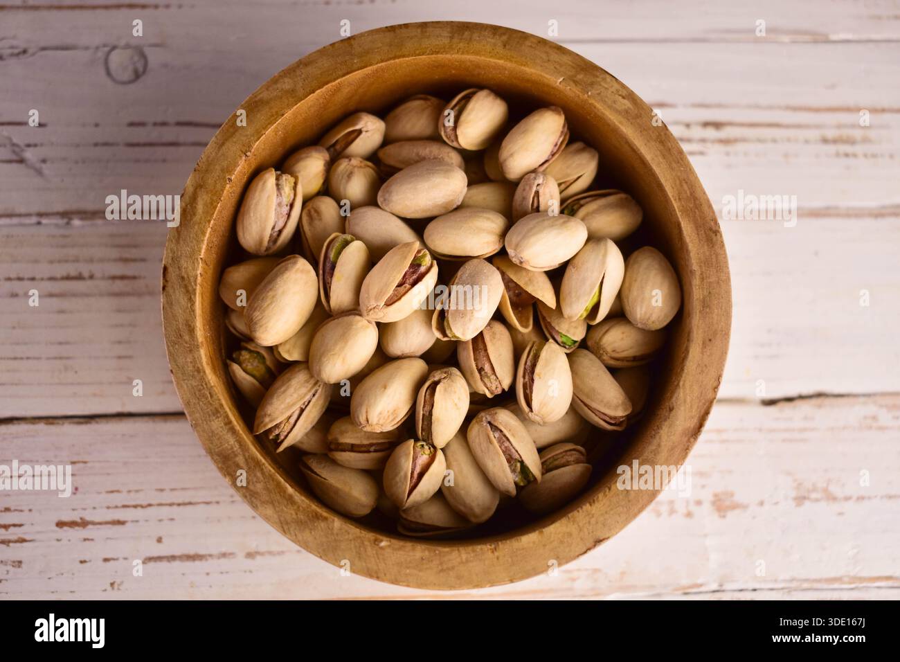 Hazelnuts in a wooden bowl. Flat lay. Stock Photo