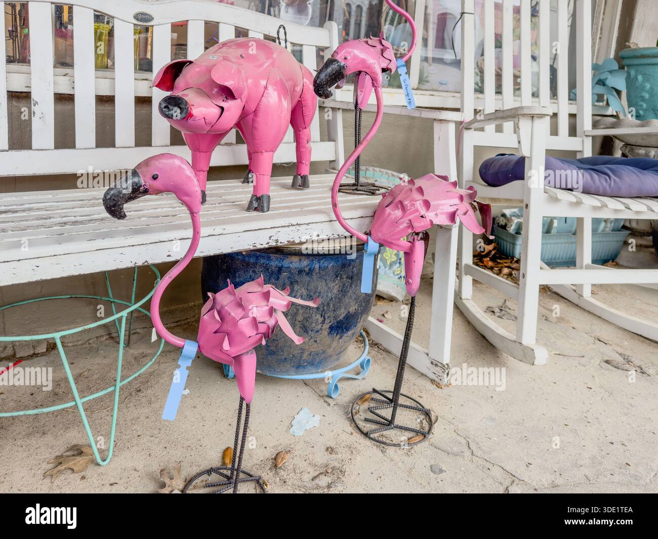 Pink pig and flamingos made of metal at a store that sells antiques and secondhand items, Smithsville, Texas, USA. - Smartphone Captured Stock Image
