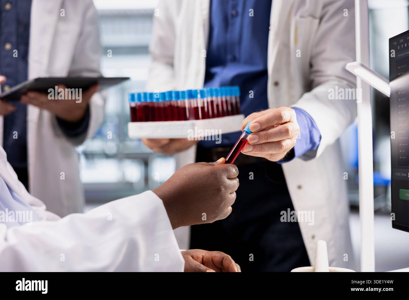 Close up of scientists examining a blood sample vial for testing, biotechnology research for genetics and molecular science. Advanced medicine and innovation in modern laboratory. Stock Photo
