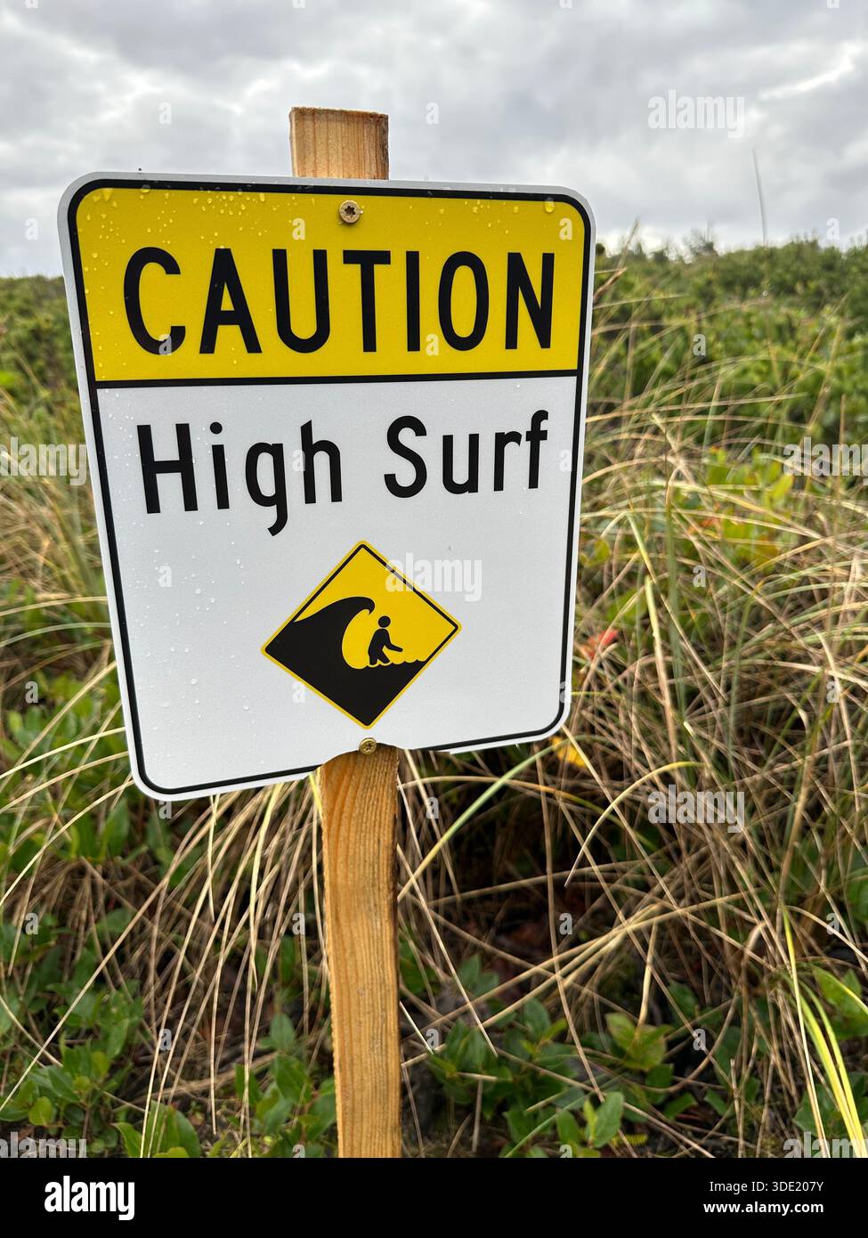 A caution sign, warning of high surf, on a beach on the Oregon