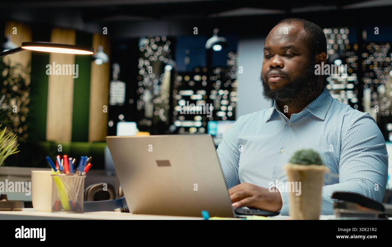 Employee Reading Black employee reading emails documenting hi-res stock photography and ...