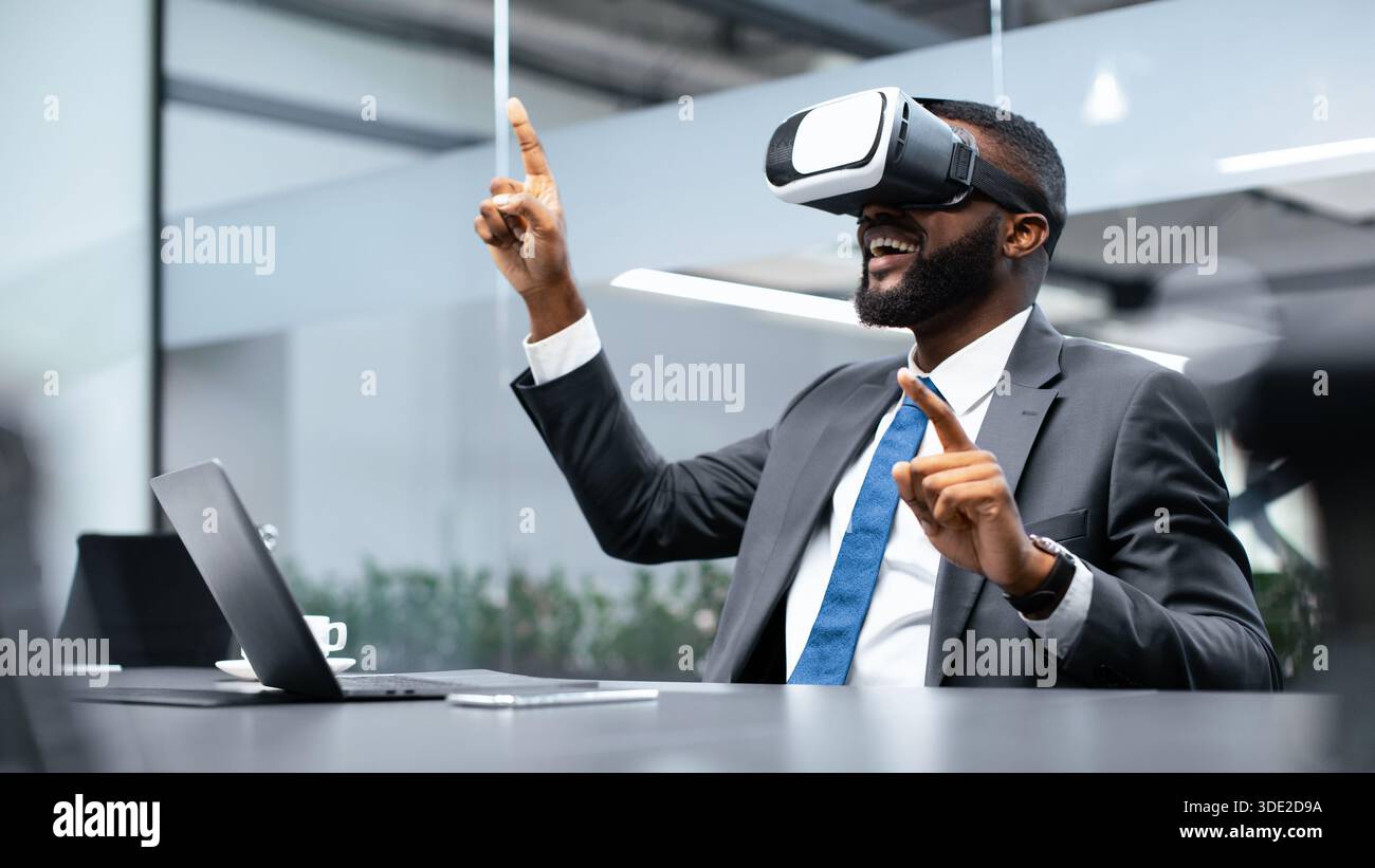 Man Uses Virtual Reality Headset in Office Setting During Work Hours Stock Photo