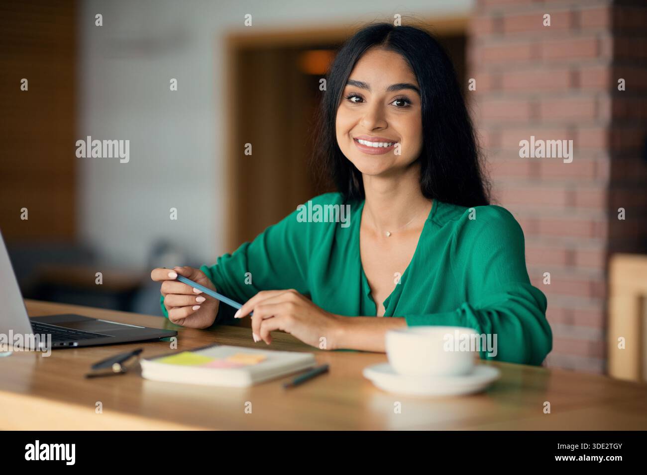 Beautiful indian woman freelancer working from cafe Stock Photo
