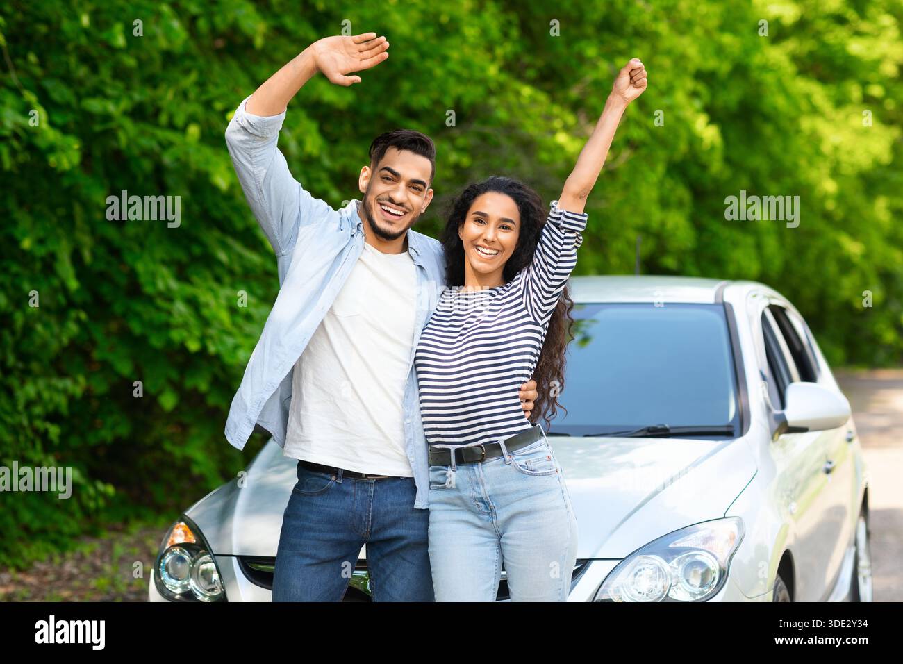 Emotional multiracial couple standing by nice auto Stock Photo