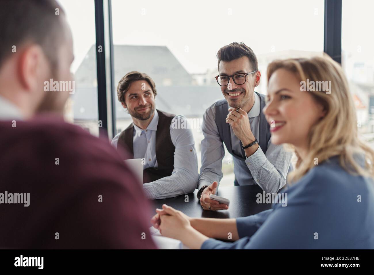 Business colleagues sharing ideas, discussing new project. Stock Photo