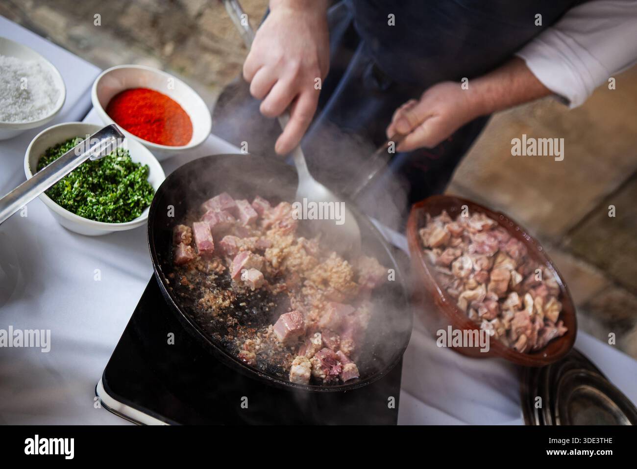 How Cookspling Meat Chef cooking cold meat and ingredients in a pan Stock Photo - Alamy