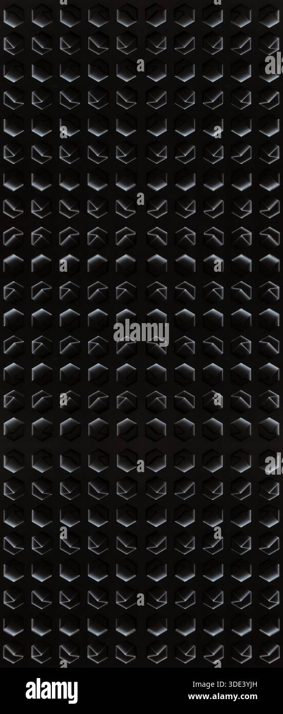 a white, textured surface featuring a grid of hexagonal indentations. Each hexagon has a three-dimensional, geometric design with internal triangular Stock Photo