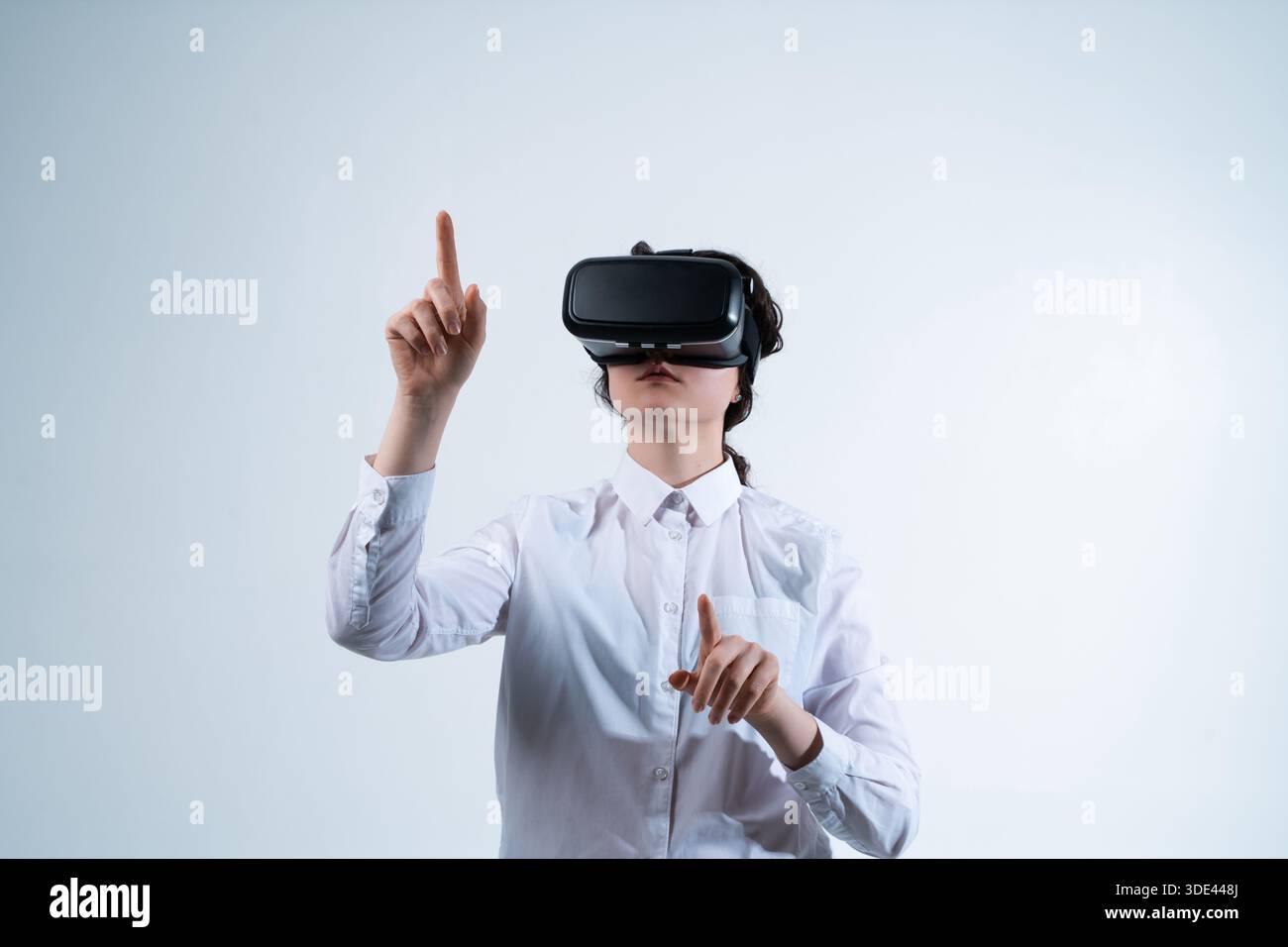 Woman finalizing virtual reality interface design decision using hand gestures in immersive VR UI UX design workspace Stock Photo