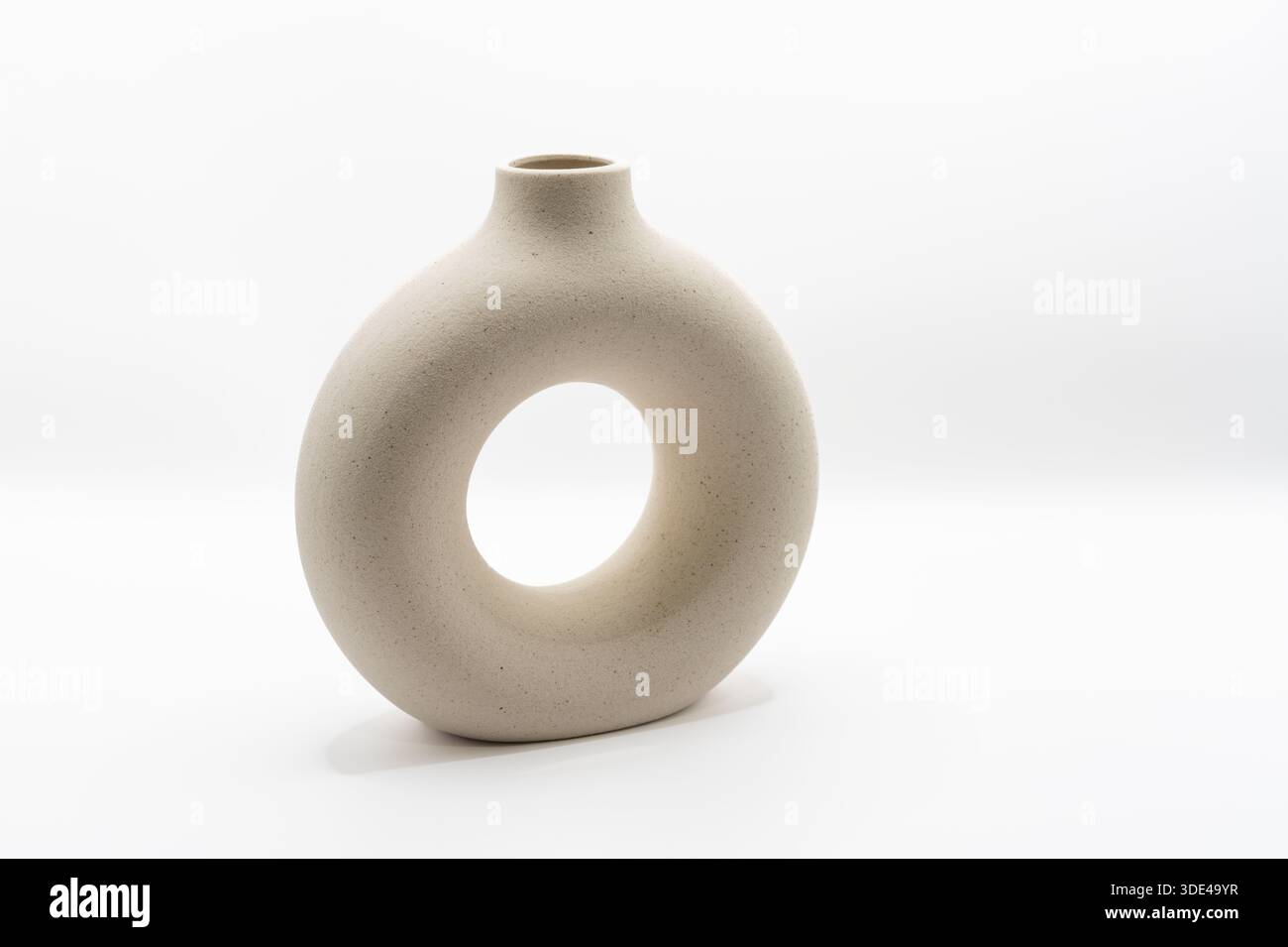 A modern ceramic flower vase, shaped to have an open cemtre Stock Photo