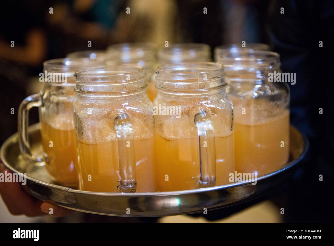 Warm Apple Cider in Mason Jars on Serving Tray Stock Photo
