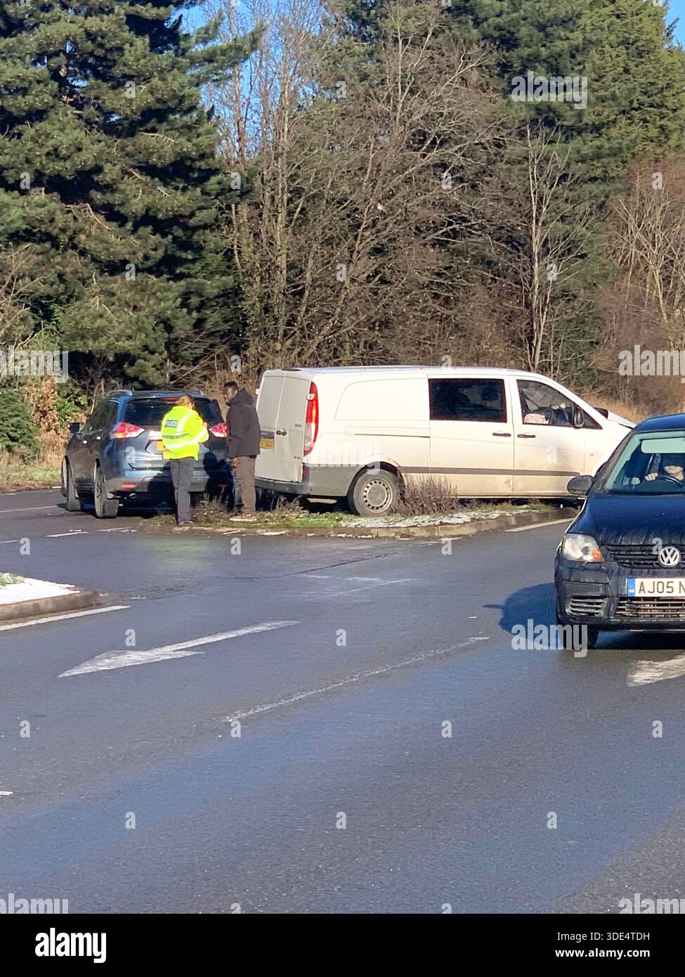 Police officers attend a traffic incident involving a white van and silver ar near a junction in snowy conditions on the A43 in Northampton Northants - Smartphone Captured Stock Image