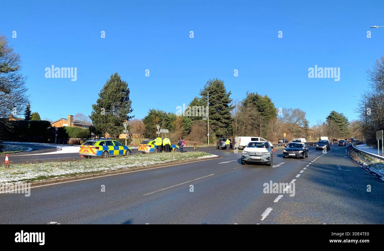 Police officers attend a traffic incident involving a white van and silver ar near a junction in snowy conditions on the A43 in Northampton Northants - Smartphone Captured Stock Image
