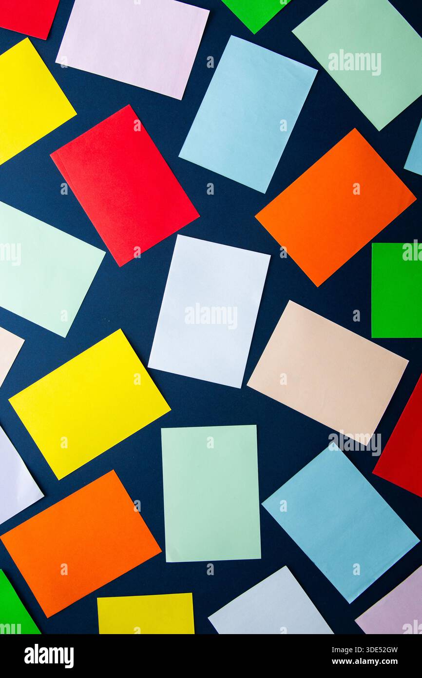 Scattered colorful rectangular paper sheets creating an abstract background Stock Photo