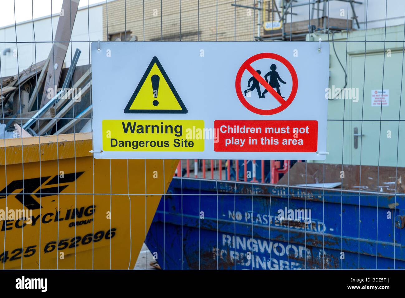 Dangerous site safety warning sign on metal fence Stock Photo