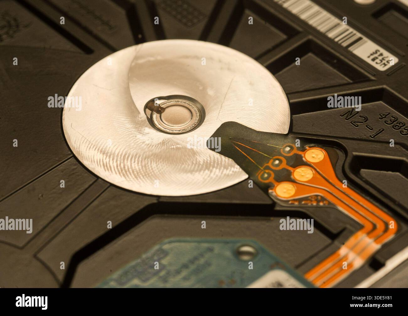 A damaged hard drive from an Apple computer. Stock Photo