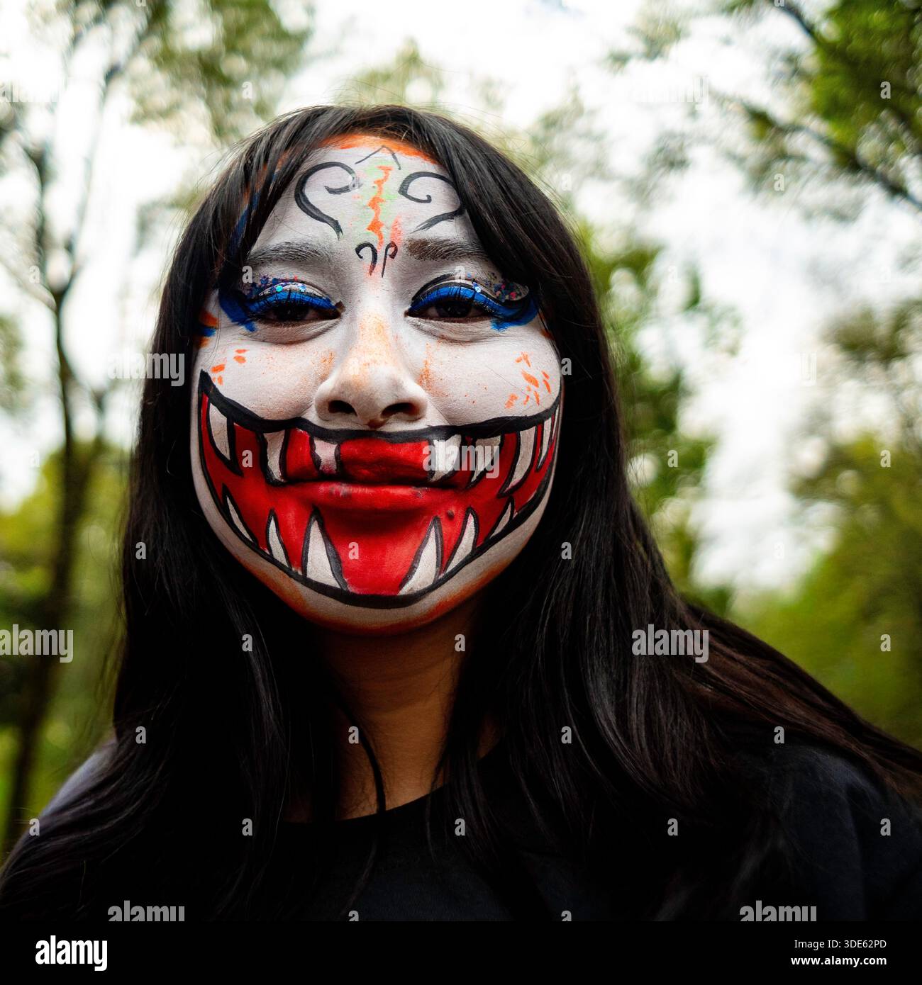Close-up portrait of a participant with skull makeup during the Day of the Dead parade in Mexico City, Mexico. Stock Photo