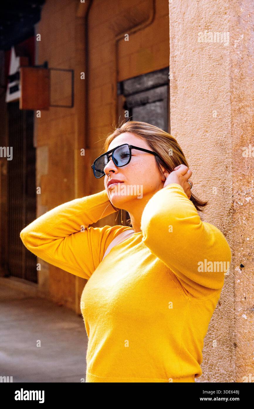 Woman in yellow sweater wearing hi-res stock photography and images - Alamy
