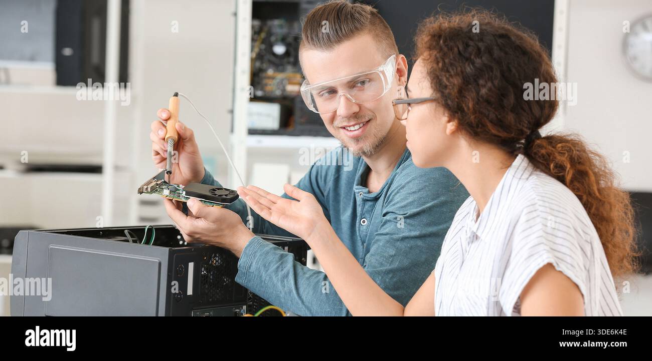 Electronic technicians working in service center Stock Photo