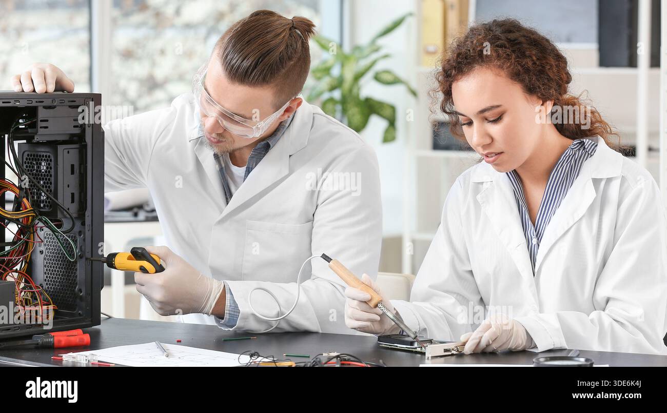 Electronic technicians working in service center Stock Photo