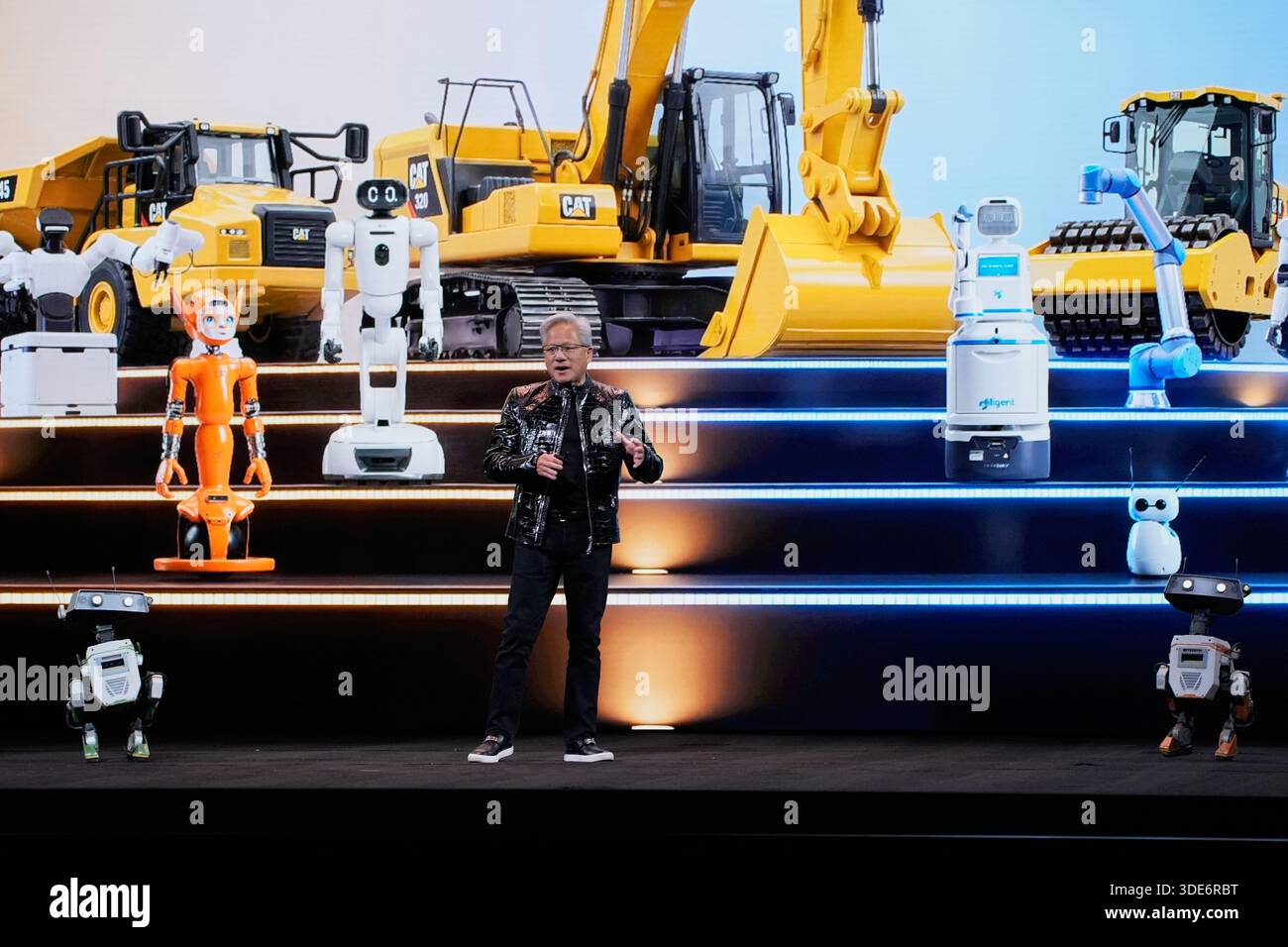 Nvidia founder and CEO Jensen Huang speaks on stage with robots during ...