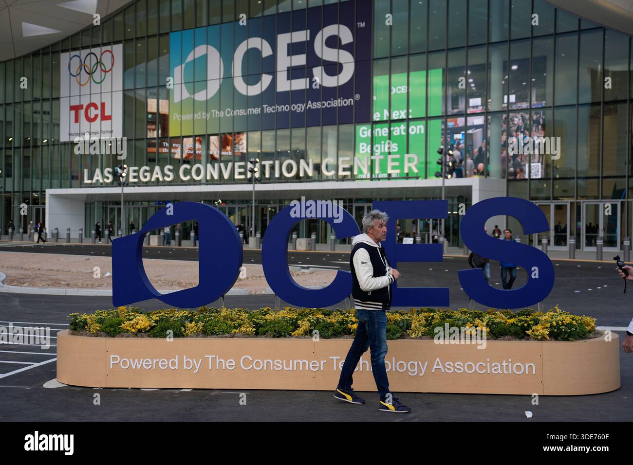People stand outside the Las Vegas Convention Center ahead of the CES ...