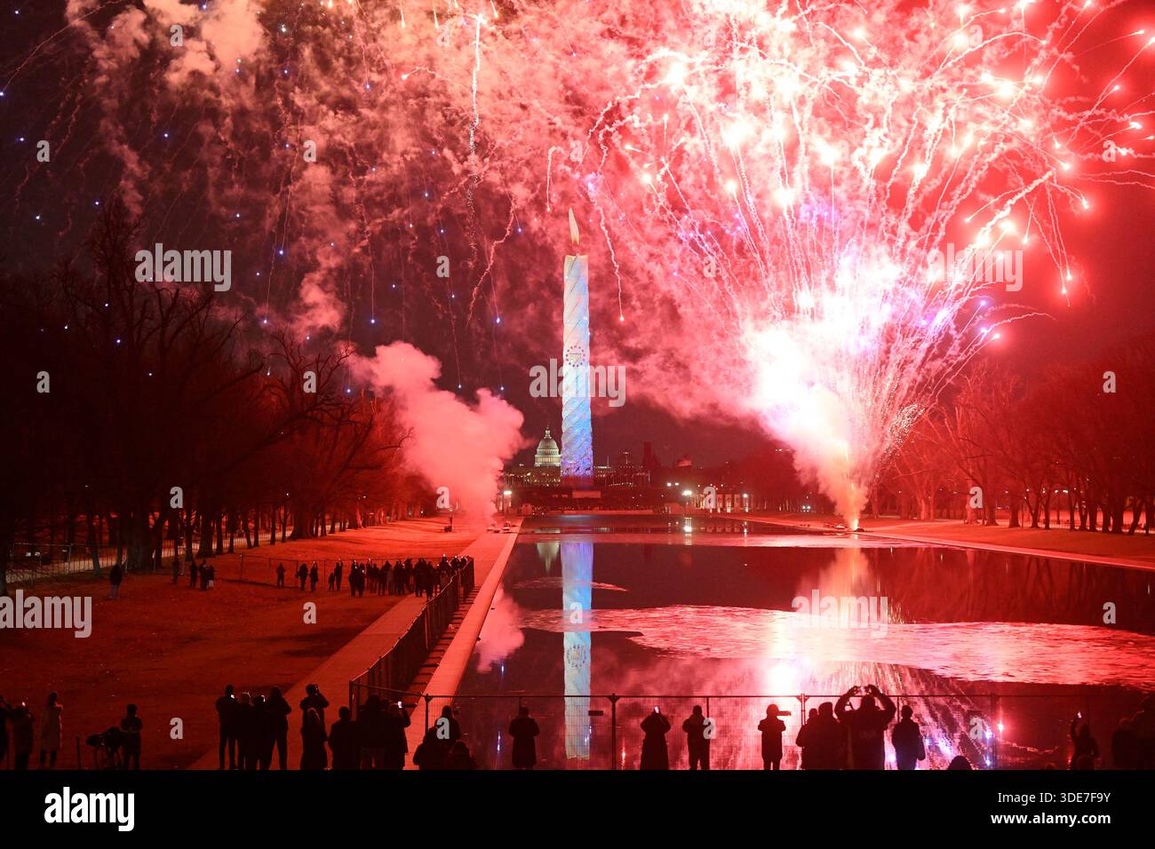 Fireworks erupt behind the Washington Monument during the United States