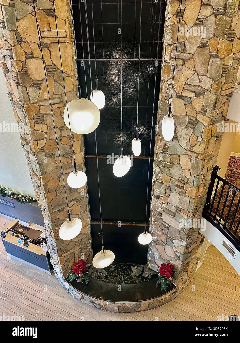 Modern Hotel Interior Water Feature with Pendant Lighting - Smartphone Captured Stock Image